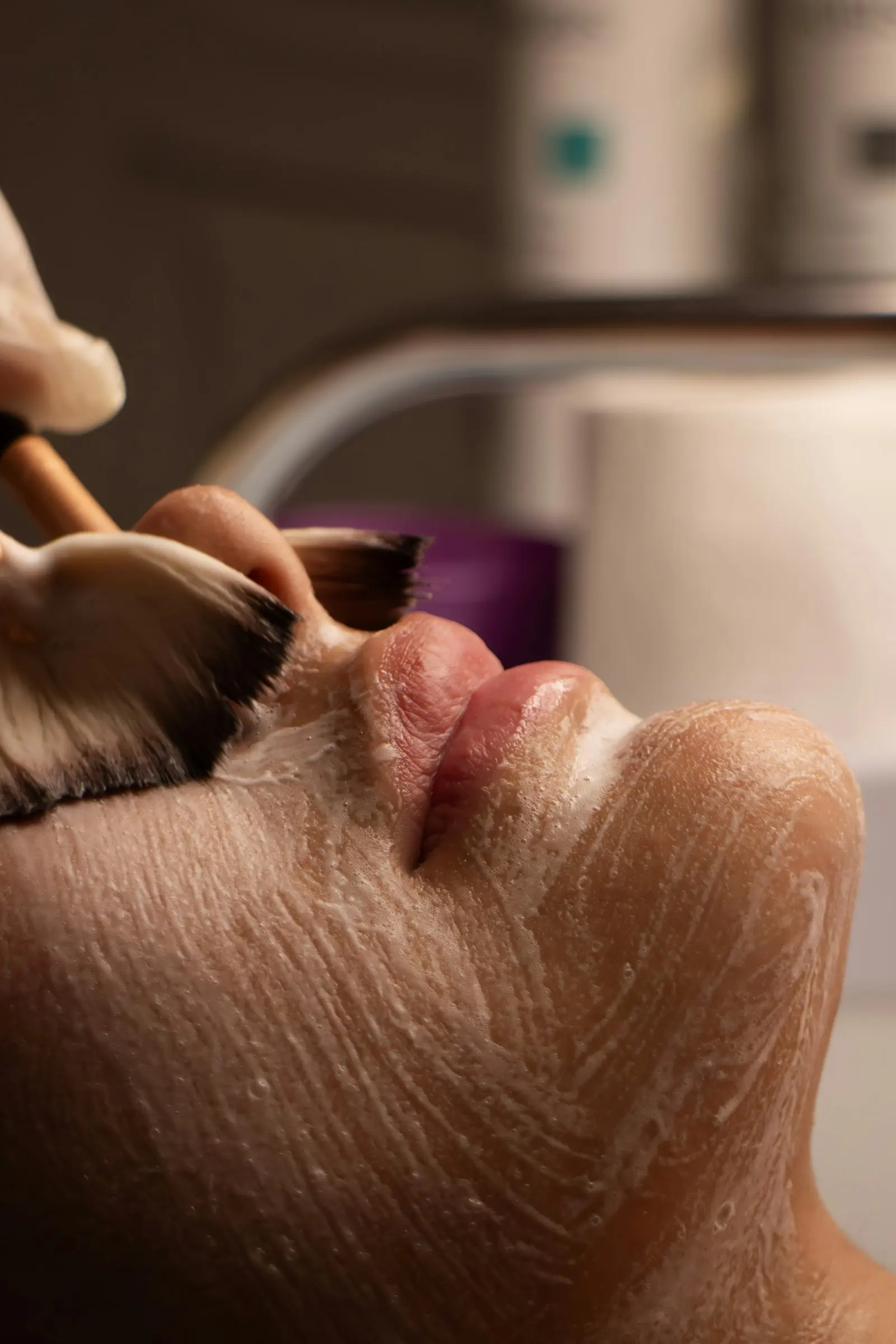 A facial treatment being applied with a brush