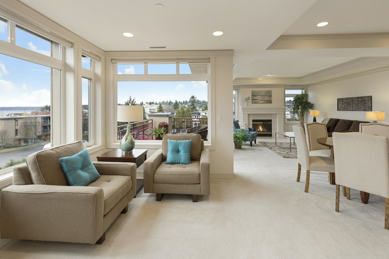 A living room with a beige couch and armchair